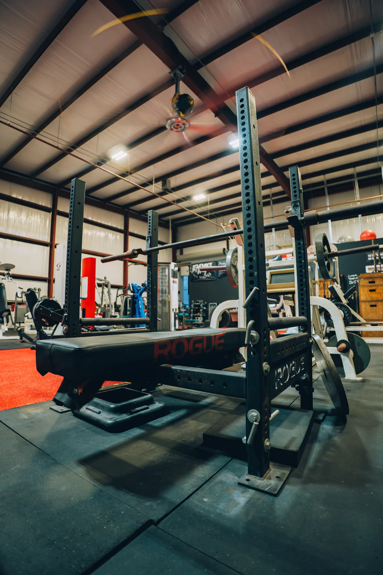 A bench and rack on the Redline Barbell training floor