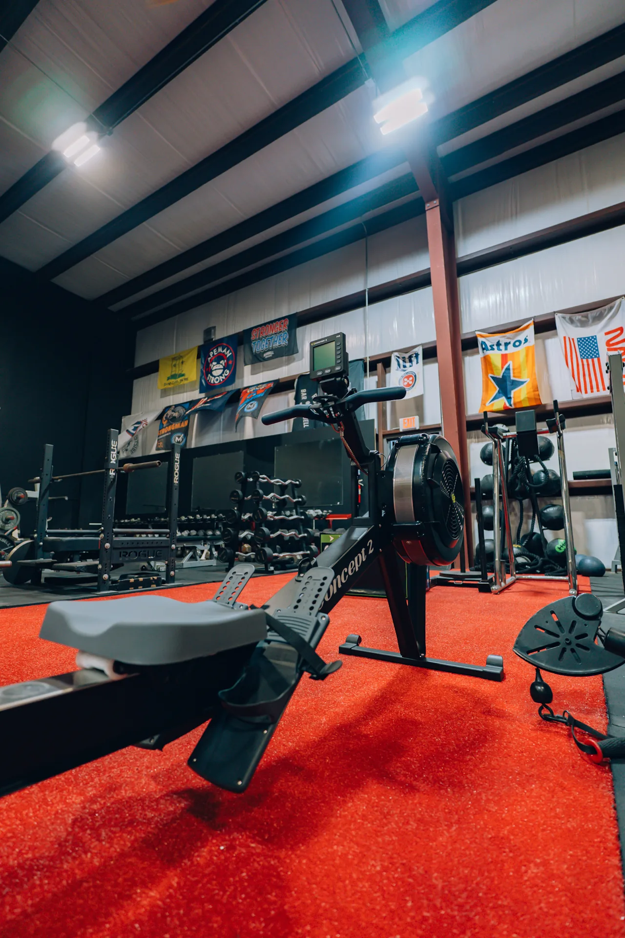 Conditioning equipment beside the red turf at Redline Barbell